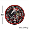 A circular embroidered patch featuring a stylized archangel figure and text that reads Put on the full armor of God we trust