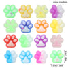A collection of colorful squishy cat paw fidget toys in various shades including green, yellow, purple, and pink.