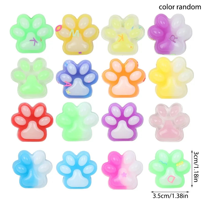 A collection of colorful squishy cat paw fidget toys in various shades including green, yellow, purple, and pink.
