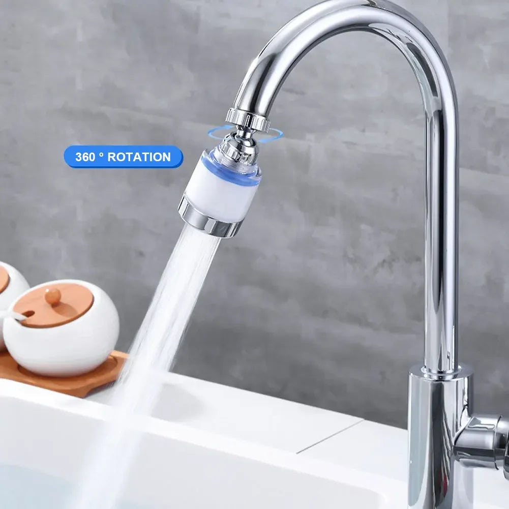 A close-up of a chrome faucet with a 360° rotating water purifier head dispensing clear water.
