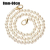 A strand of small, round, off-white pearls on a gold-toned chain strap.
