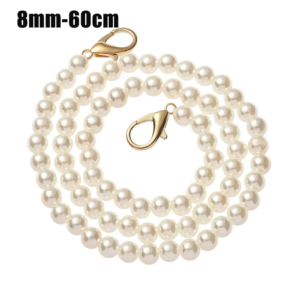 A strand of small, round, off-white pearls on a gold-toned chain strap.