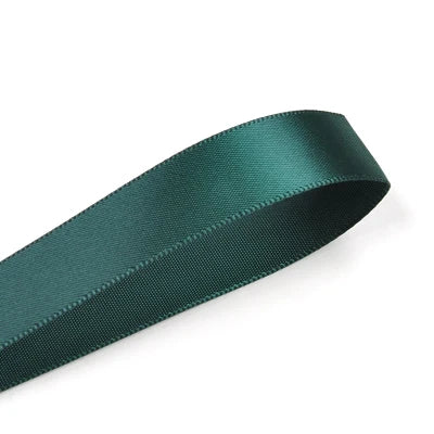 A roll of dark teal double face satin ribbon.