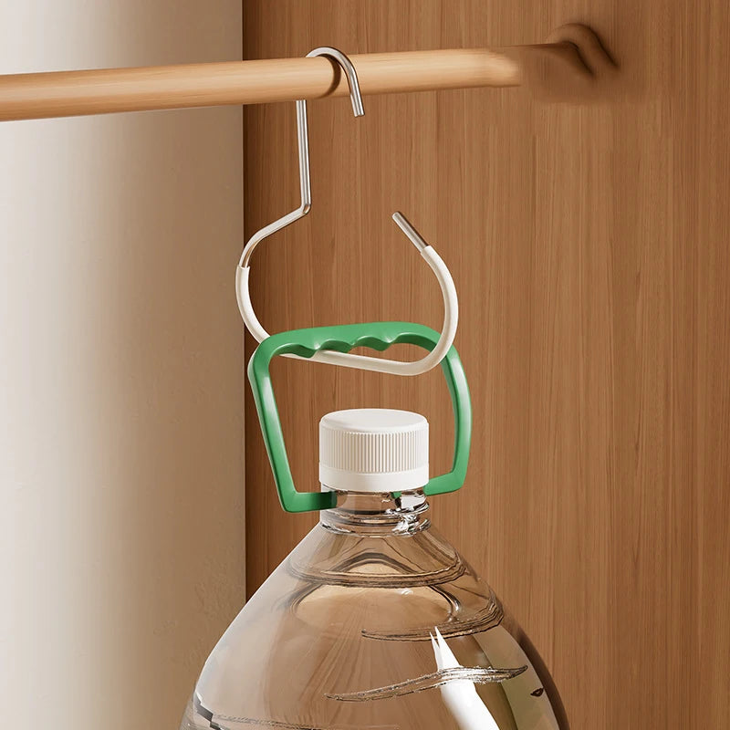 A green and white hanger hook system is shown hanging from a wooden rod against a light brown wall.