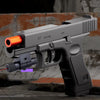 A gray toy pistol with an orange barrel and a wooden stock is shown in a close-up view.