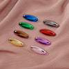 A set of eight solid color scarf pins in various shades including blue, green, silver, red, and purple, displayed on pink fab