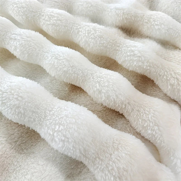 Nahaufnahme einer weißen Plüsch-Faux-Fur-Decke mit sichtbarer Textur und Falten.