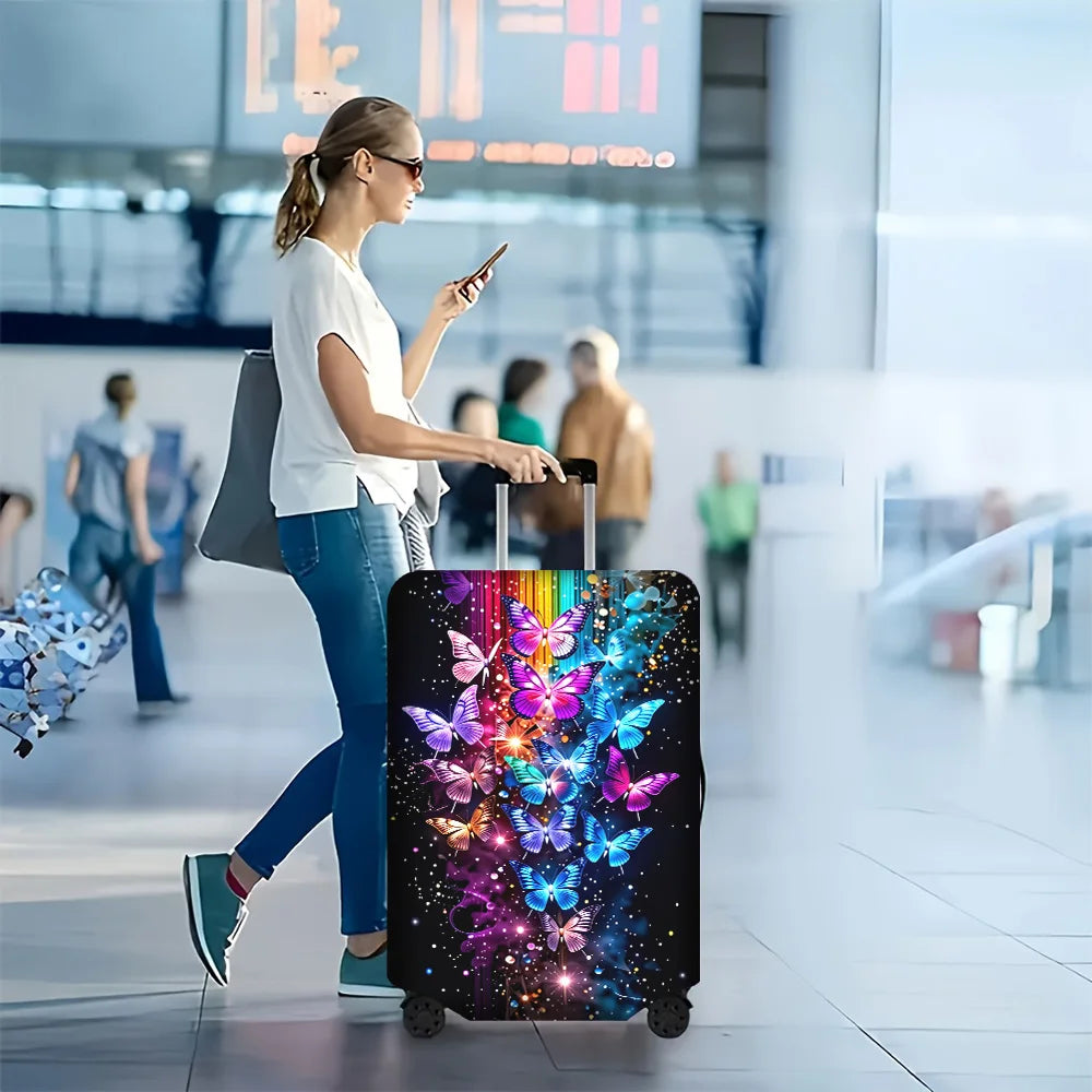 Iridescent butterfly print luggage cover on a rolling suitcase being pulled through an airport terminal.