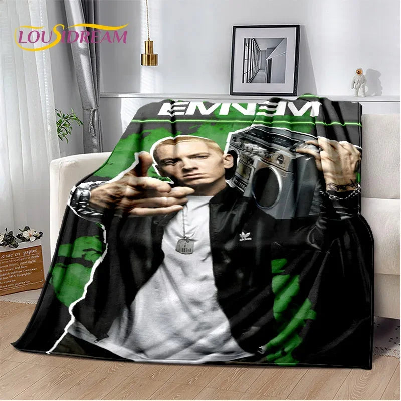 A throw blanket featuring a graphic of Eminem and 2Pac with a dark background.