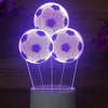 Purple LED night light featuring three glowing soccer balls suspended above a base.