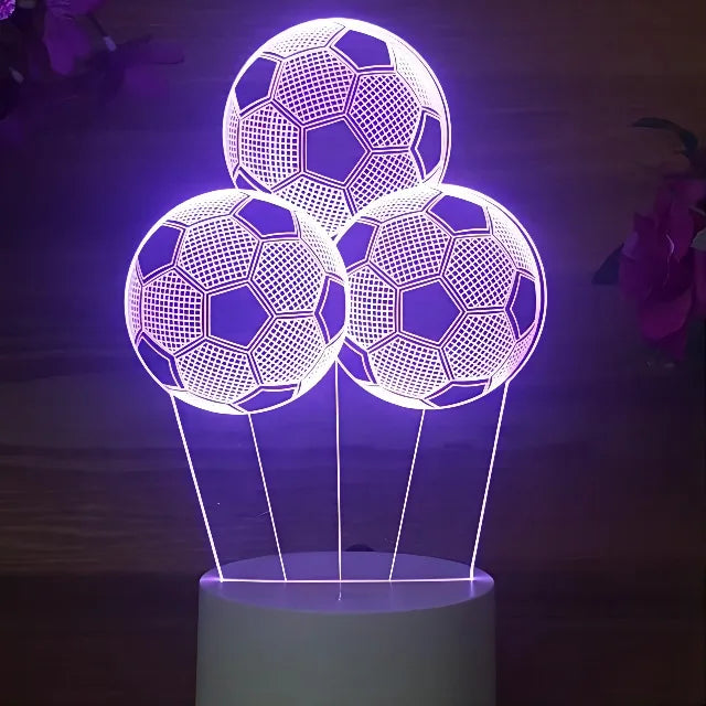 Purple LED night light featuring three glowing soccer balls suspended above a base.
