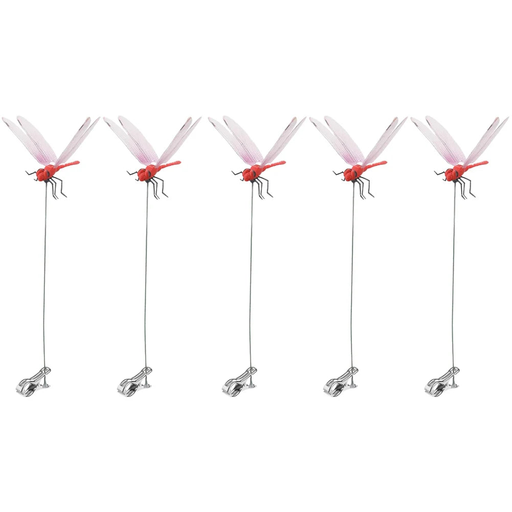 A set of lifelike dragonfly clips with pink and red wings for garden decoration.