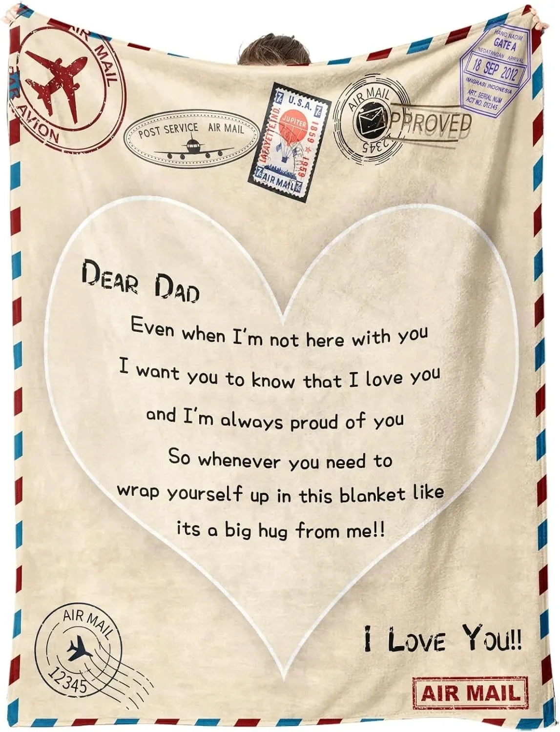 A cream-colored fleece throw blanket with a heart design and text expressing love to a dad.