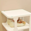 A white stackable vertical shoe rack holding several pairs of tan and brown shoes.