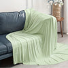 Light green ice silk blanket draped over a dark blue sofa.