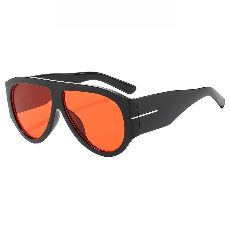 Gafas de ojo de gato Y2K oversize con montura negra y lentes naranja brillante.
