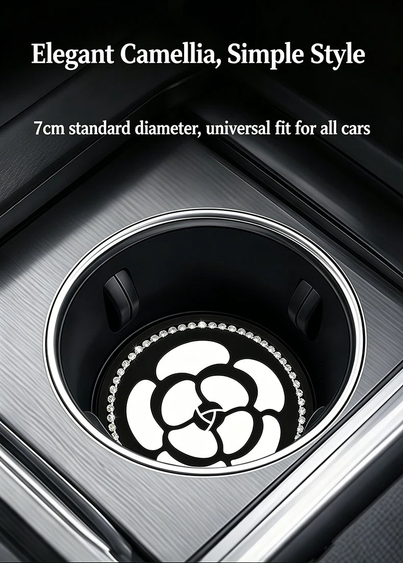 A close-up view of a black camellia flower pattern coaster fitting into a car cup holder.