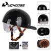 Black retro open face motorcycle helmet with a clear visor and brown strap, shown with accessories.