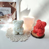 A display of white and pink silicone rose bear molds used for crafting candles, soap, and resin
