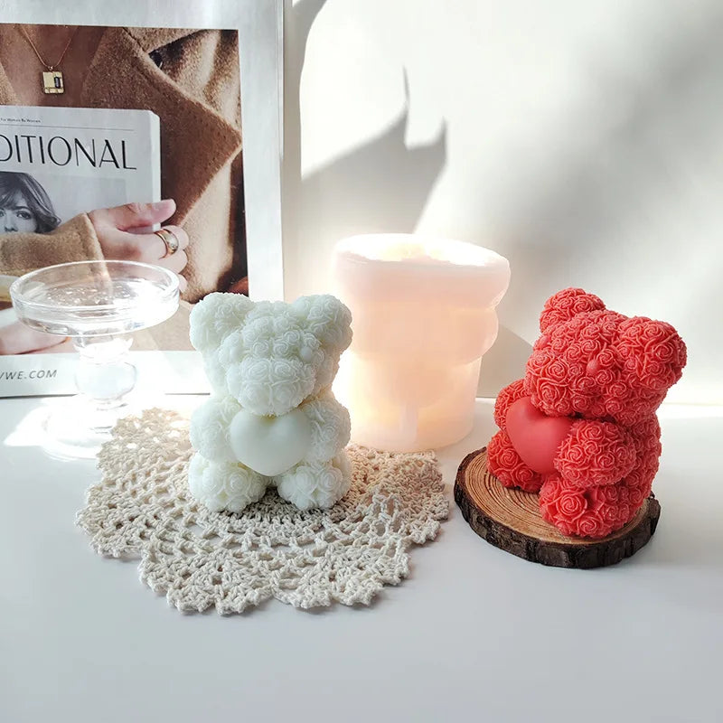 A display of white and pink silicone rose bear molds used for crafting candles, soap, and resin