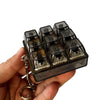 A hand holds an LED mechanical keychain fidget toy with custom keycaps.