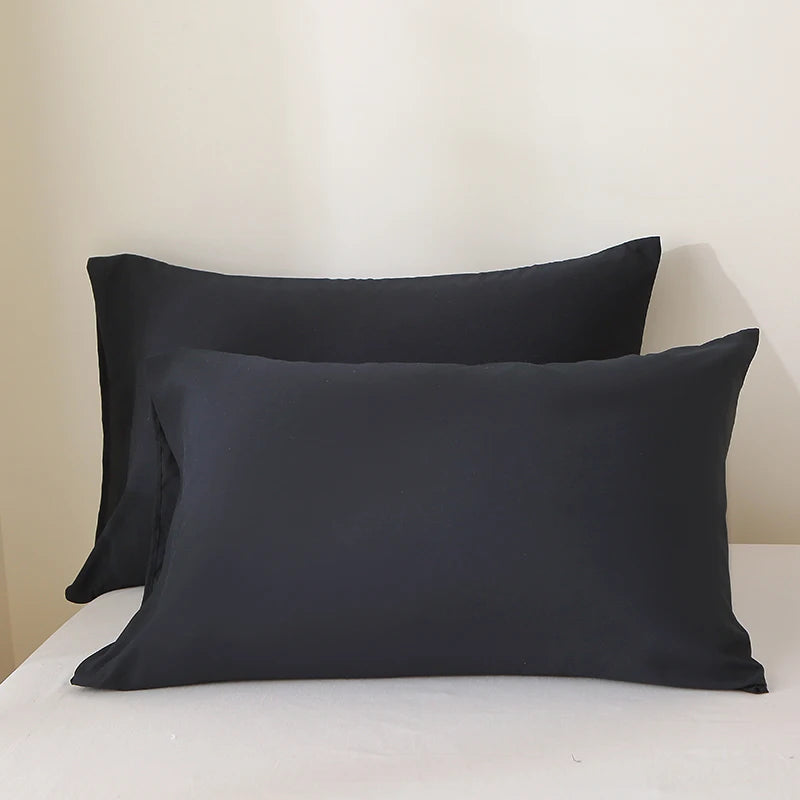 A set of three black premium brushed fabric pillow covers displayed on a white surface.