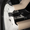 A black magnetic car phone mount with a cup holder base is shown in a white and beige interior setting.
