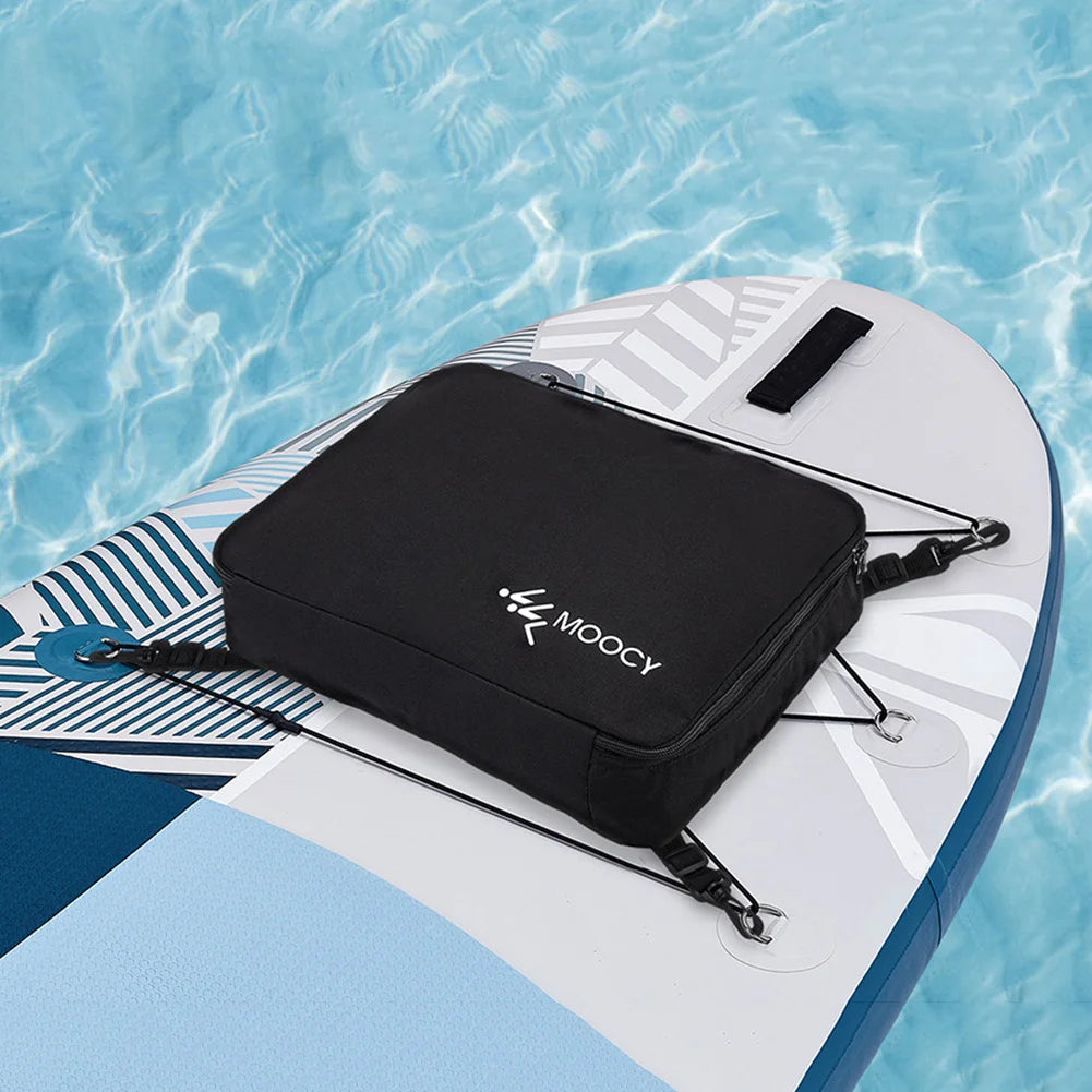 A black waterproof paddle board deck bag with a cooler lining resting on a light blue water surface.