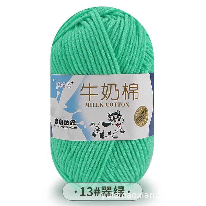 A ball of bright green milk cotton blend yarn with a label in Chinese and English.
