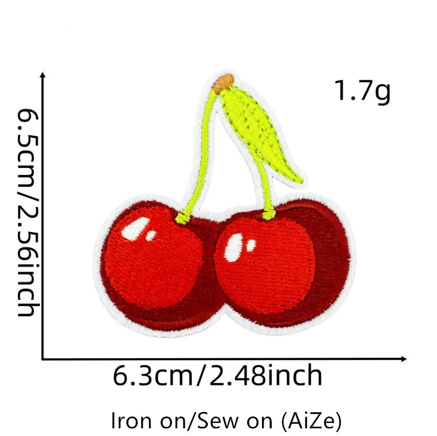 A yellow cherry embroidered patch on a red felt background, measuring 1.7g.