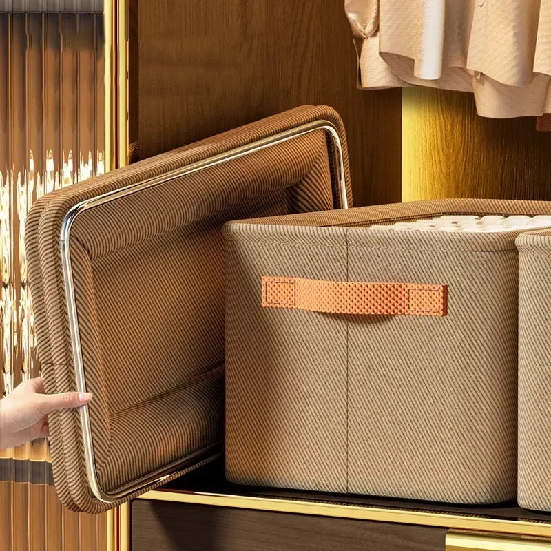 A brown fabric storage box is being pulled out from a wooden drawer, showing its textured surface and metallic trim.