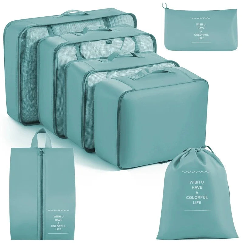 A set of teal travel packing cubes and storage organizer bags for clothing.