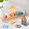 A set of wooden sorting and stacking toys in various colors like orange, yellow, green, and blue for toddlers.
