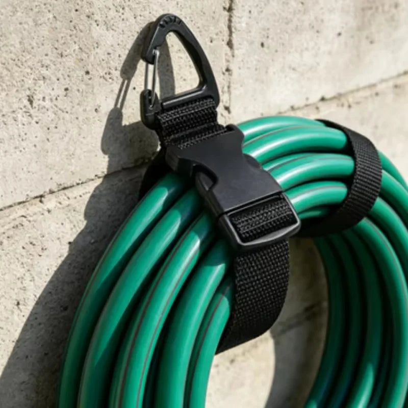 A coil of green heavy duty extension cords bundled together with black plastic organizers.