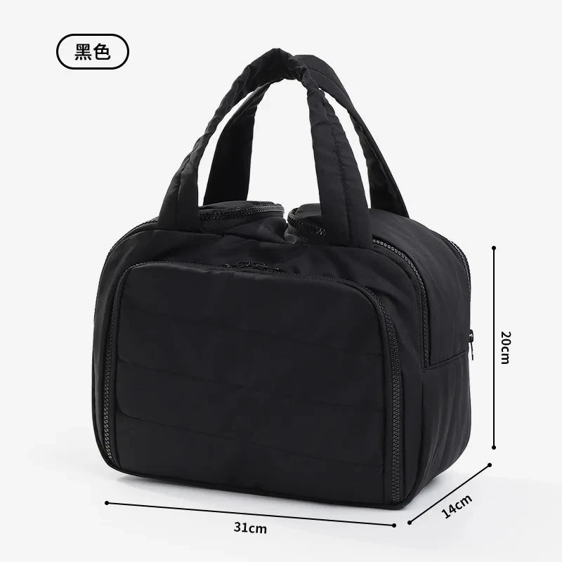 Black large travel makeup bag with a wide opening shown from the side.