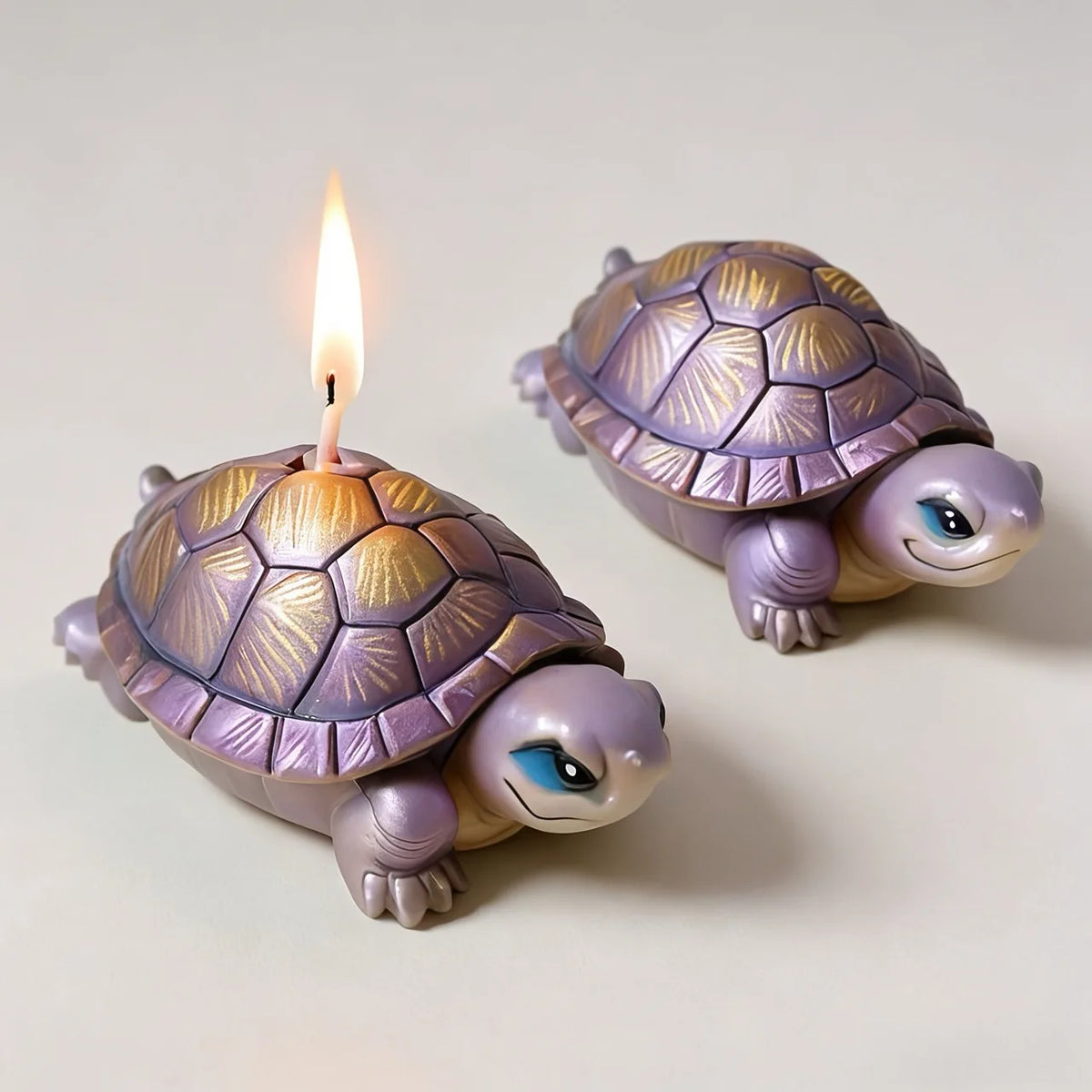 A small purple lotus flower silicone mold shaped like a turtle with a lit candle.