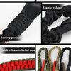 Various components of a tactical rifle sling including a steel metal buckle, elastic rubber, and colorful rope.