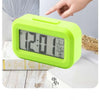 A lime green digital desk lamp with a display showing 12:01 and temperature settings, demonstrating back light and bright lig