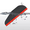 A black carbon fiber car side mirror rain and sun visor is shown being splashed by water.