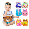 A baby is wearing a colorful wipeable bib with various themed pockets for weaning toddlers.