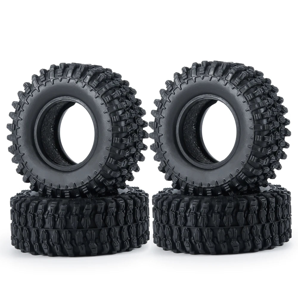 A pair of black rubber mud terrain tires for Axial SCX24 and TRX4M, stacked on top of each other.