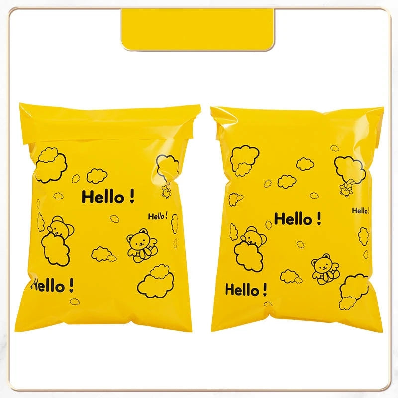 A pack of yellow self-sealing mailing bags featuring a Hello bear design.