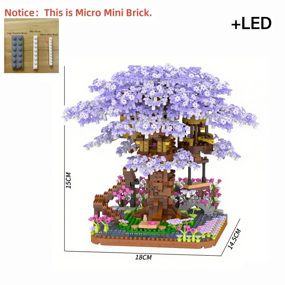 A detailed micro building block model of a pink sakura treehouse with purple flowers and an LED light.