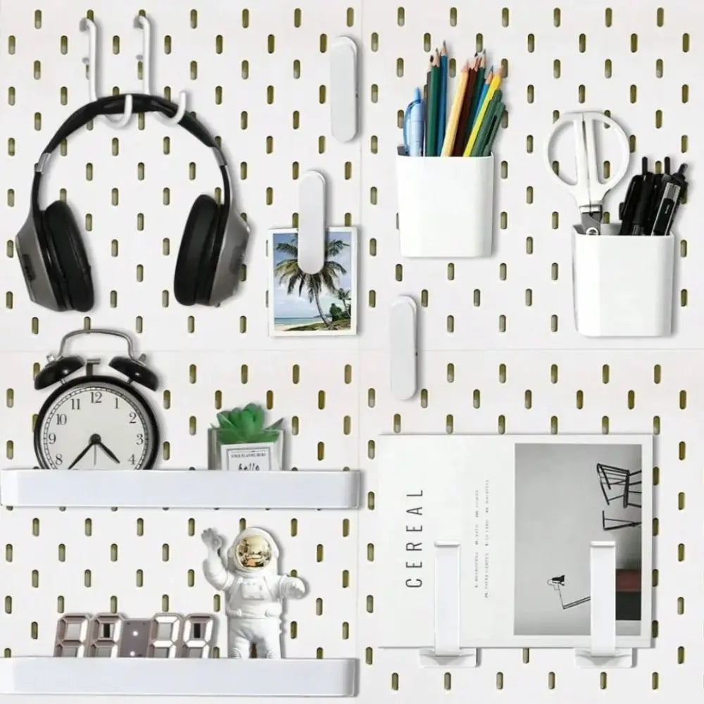 A wall-mounted pegboard organizer featuring various hooks and white storage boxes for tools and accessories.
