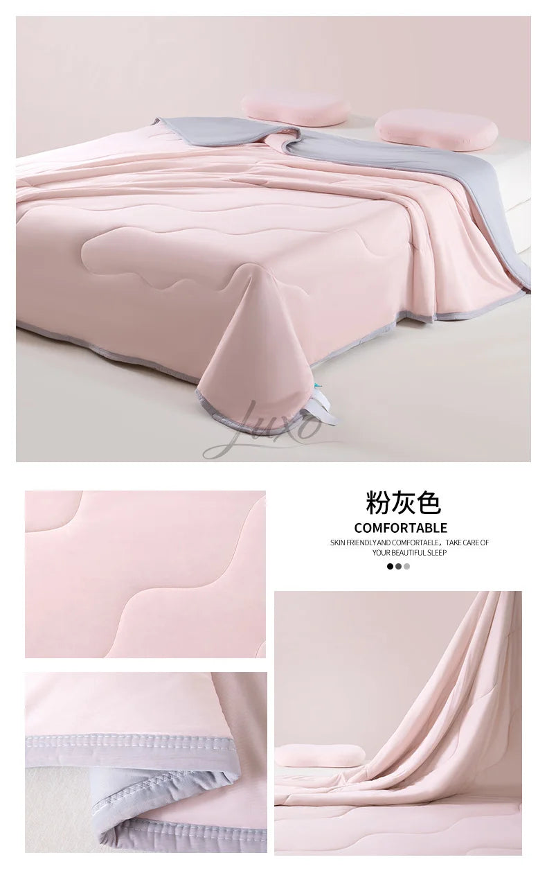 A pink ice silk cooling blanket draped over a surface, showing its soft texture and light gray trim.