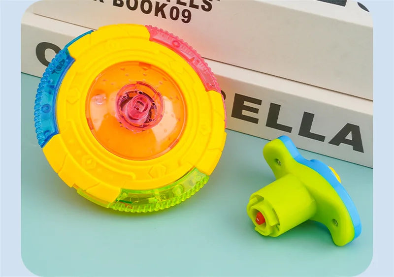 A yellow and pink glowing musical spinning top is shown next to its disassembled parts on a light blue surface.