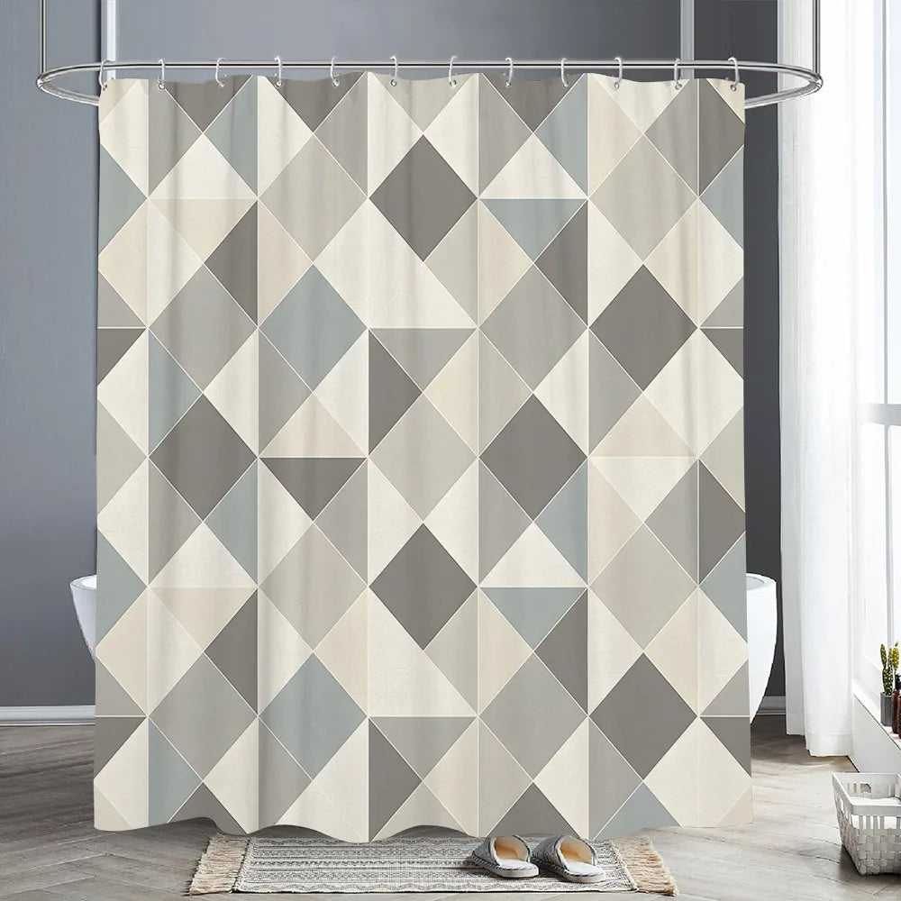 Abstract geometric shower curtain featuring a pattern of gray and beige triangles in a modern bathroom setting.