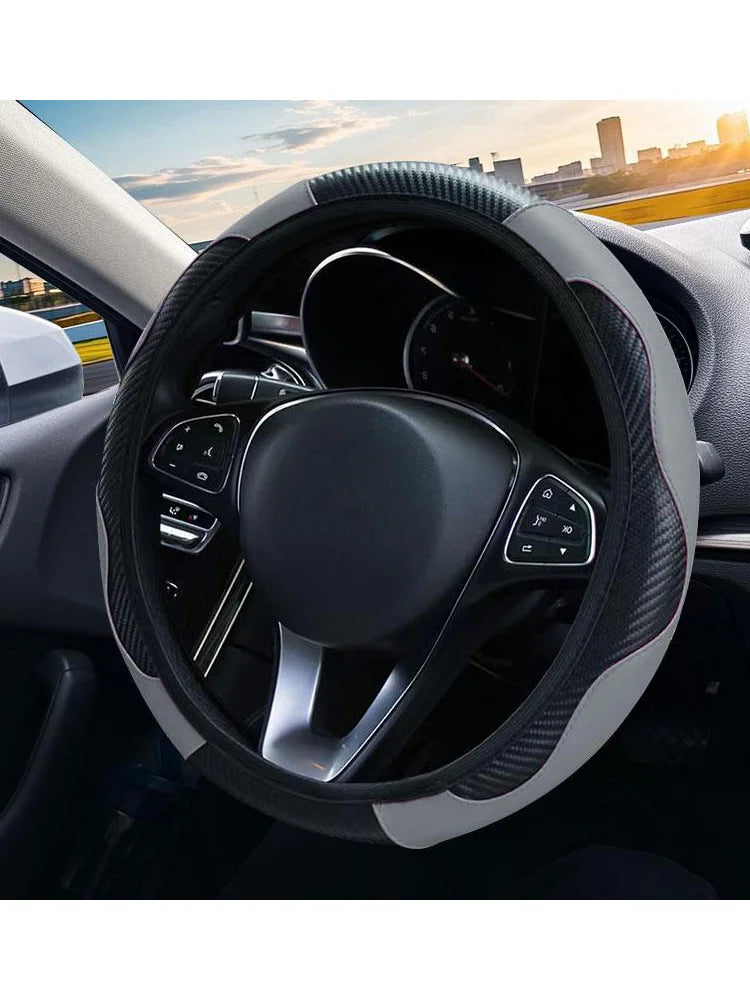 Interior view of a car steering wheel covered with a black textured grip and leather-like material.