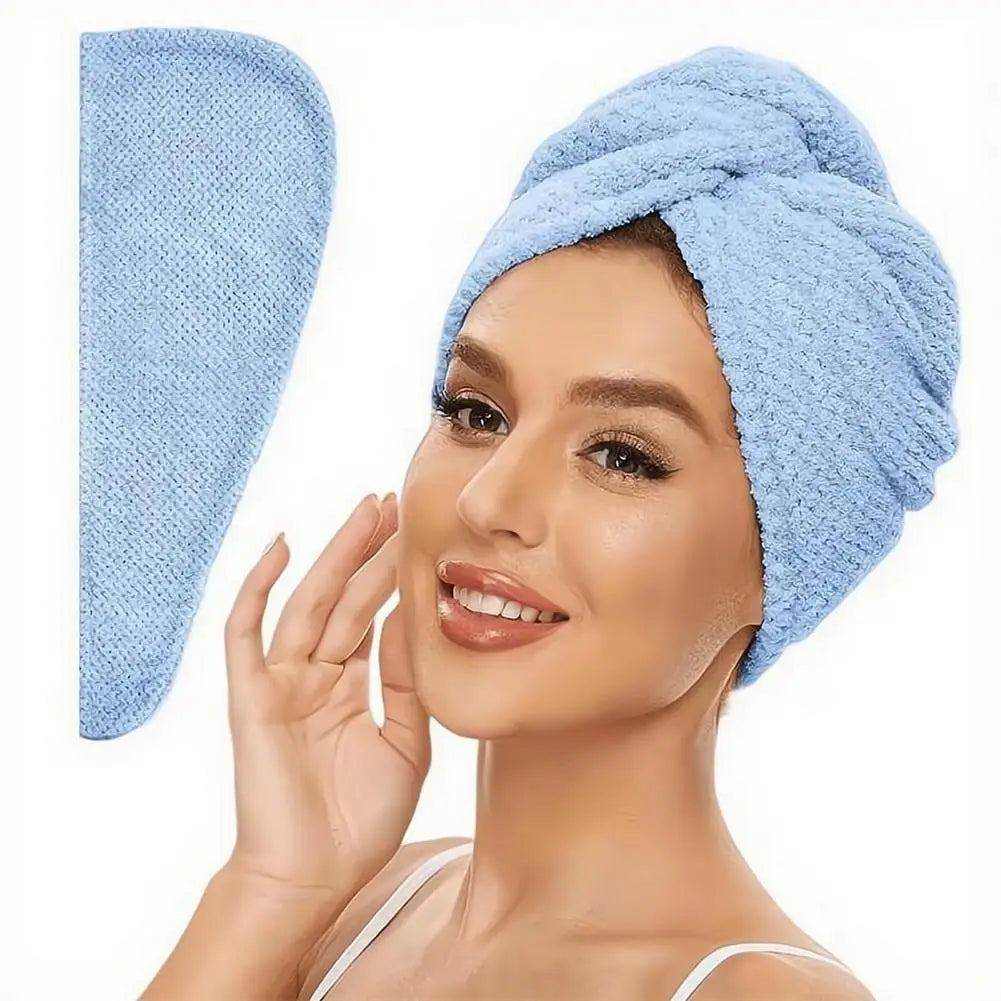 A woman is wearing a light blue microfiber hair drying towel wrap on her head.