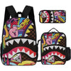 A set of two black backpacks featuring a shark graphic cartoon print with pink and yellow accents.